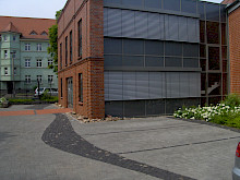 Parkplatz und Eingangsbereich eines Firmengebäudes aus Betonpflaster, Basaltpflaster und Klinkerpflaster.